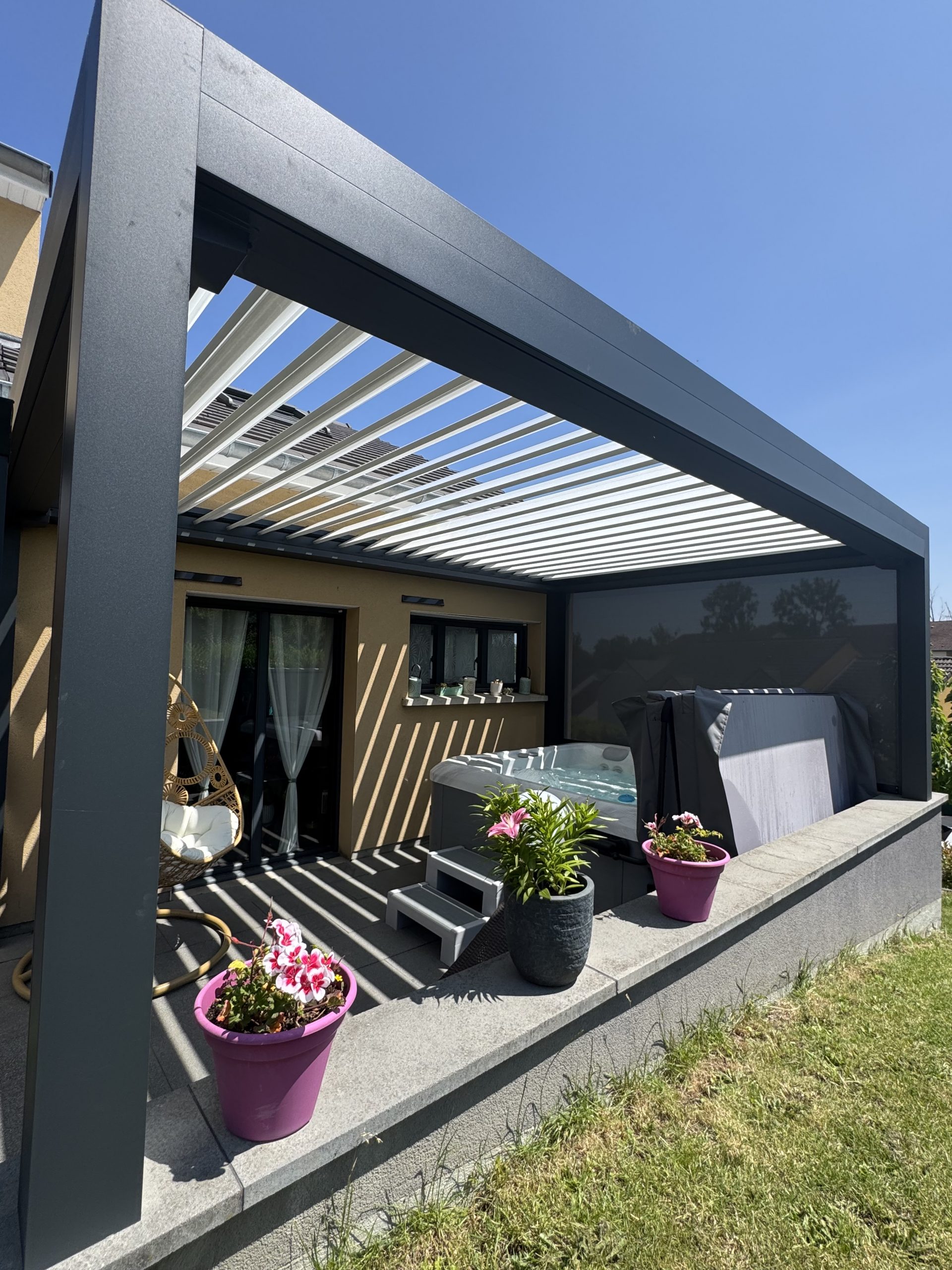 Pergola bioclimatique avec ossature en aluminium laquée gris anthracite + Lames orientables en aluminium laquées blanc