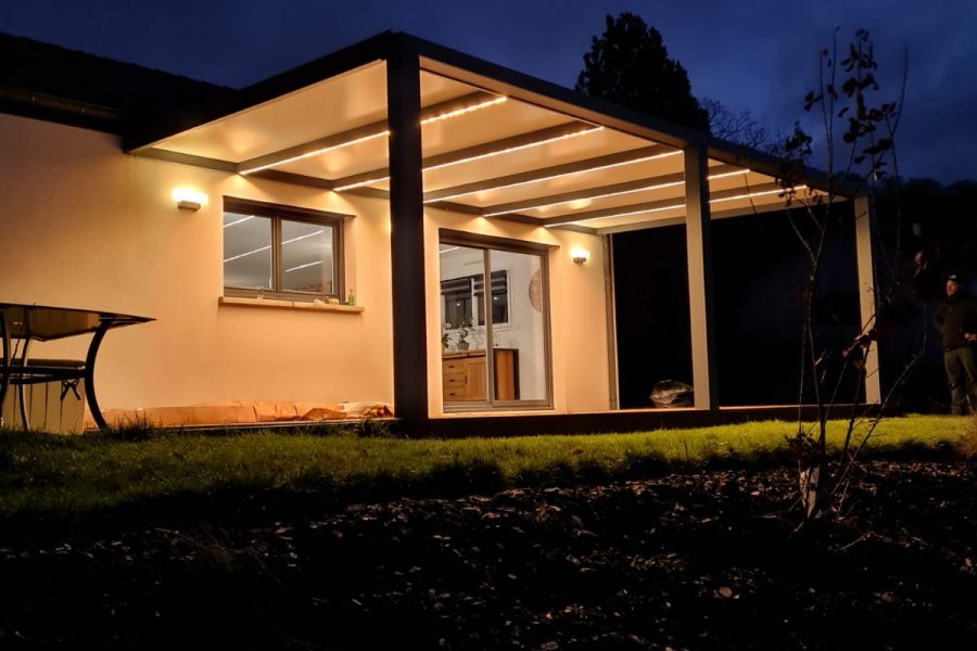 Pergola fixe avec ossature en aluminium laquée gris anthracite avec toiture panneaux sandwich et éclairage leds intégrés dans les chevrons