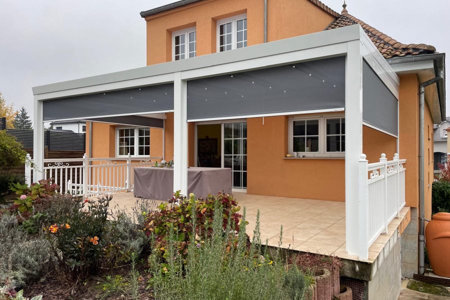 Store screen zip solaire coffre blanc et toile gris clair 9007 et pose sur pergola entre poteaux.